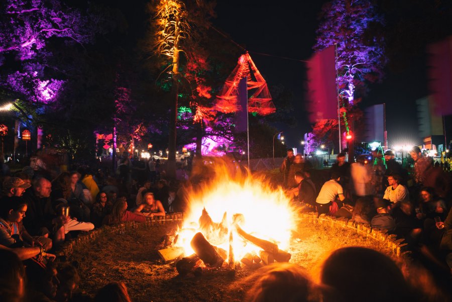 People sitting around a campfire at Electric Picnic