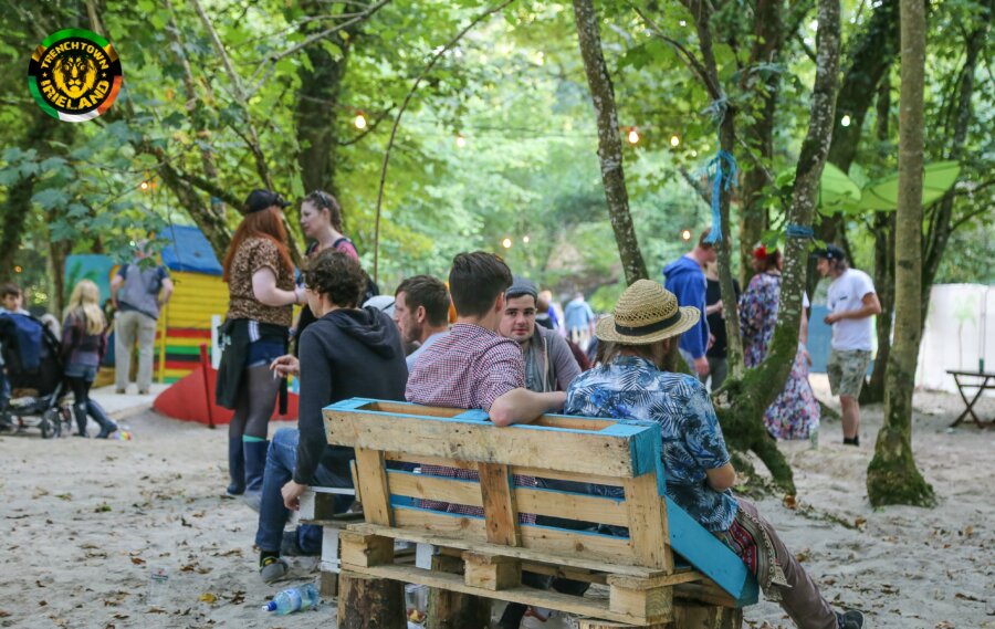 Friends sitting on a bench in Trenchtown