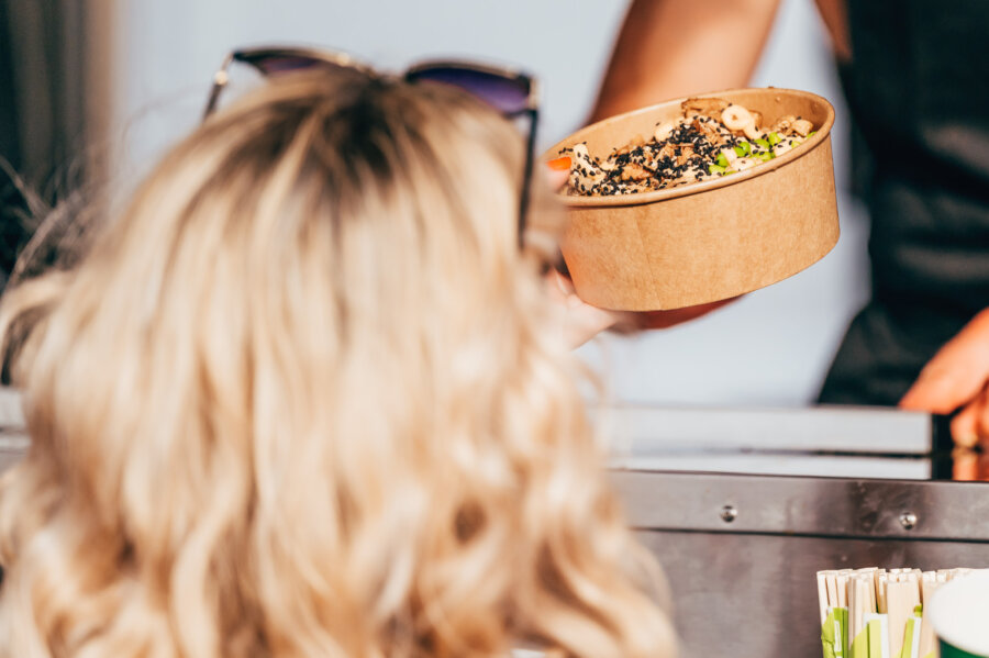 person serving a salad bowl