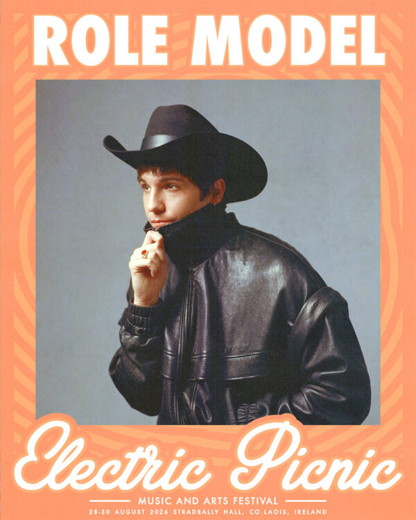Role Model wearing a zipped up leather jacket and cowboy hat - Electric Picnic Logo